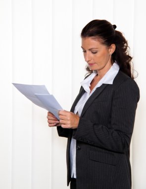 Business woman reading a letter clipart