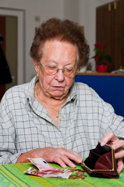 Pensioner counts their money from the pension clipart