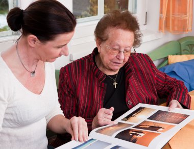 Senior leafing through photo album clipart