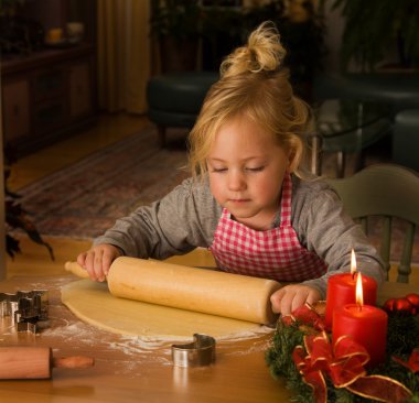 Child at christmas in advent when baking cookies clipart