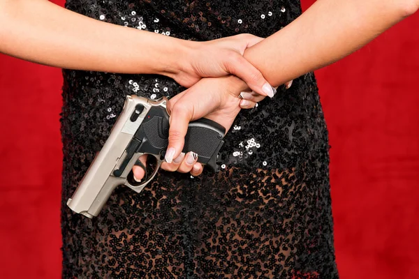 stock image Woman in evening dress with concealed weapon