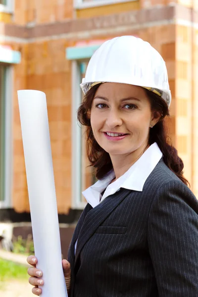 Architect with plan on construction site — Stock Photo, Image