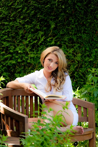 Frau liest im Garten ein Buch — Stockfoto