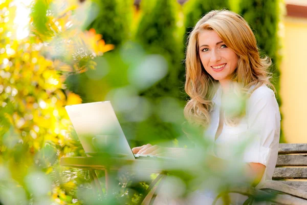 Frau mit Laptop im Garten — Stockfoto