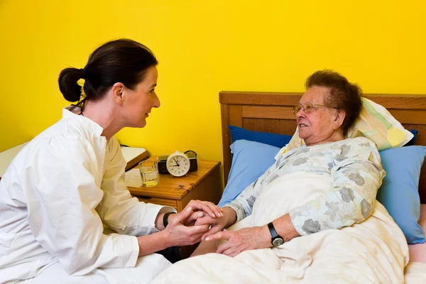 Медсестры присматривали за старухой в доме престарелых — стоковое фото