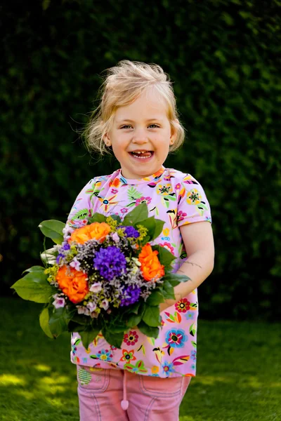 Enfant avec un bouquet de fleurs. cadeau pour la mère — Photo