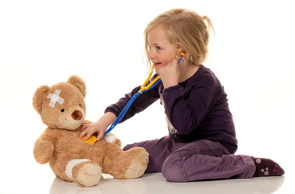 Child with a stethoscope as a medical doctor. pediatrician exami Stock Image