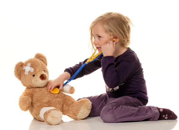 Child with a stethoscope as a medical doctor. pediatrician exami Stock Photo