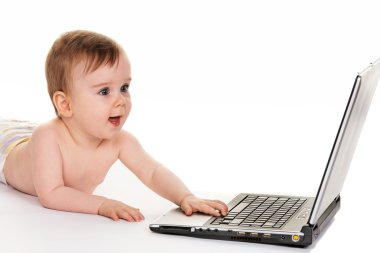 Small child with a laptop computer during play clipart