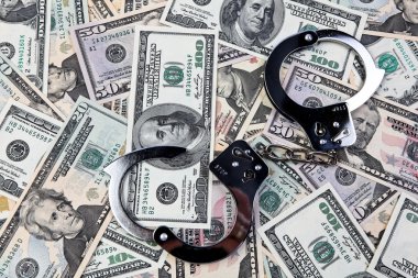 Dollar currency notes and handcuffs. clipart