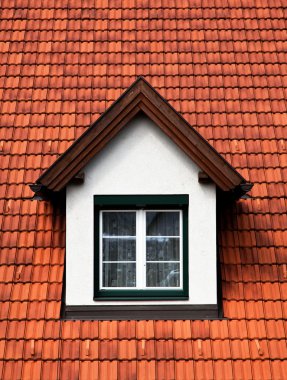 Mullioned windows in a red roof dormer clipart