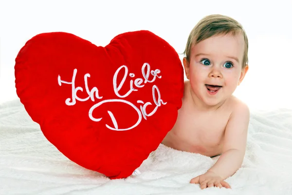 Small child with a baby cushion i love you — Stock Photo, Image