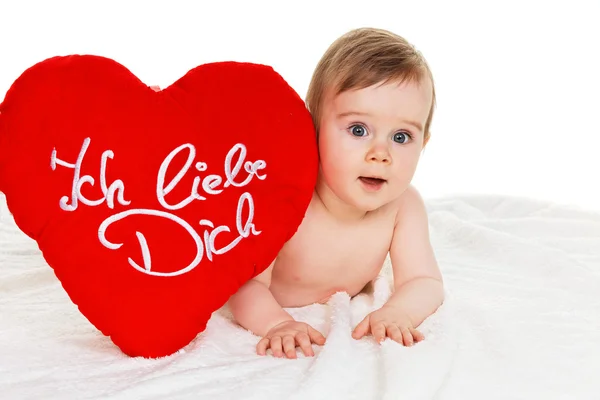 Small child with a baby cushion i love you — Stock Photo, Image