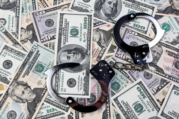 Dollar currency notes and handcuffs. — Stock Photo, Image