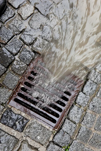 Lid of a channel for rain water — Stock Photo, Image