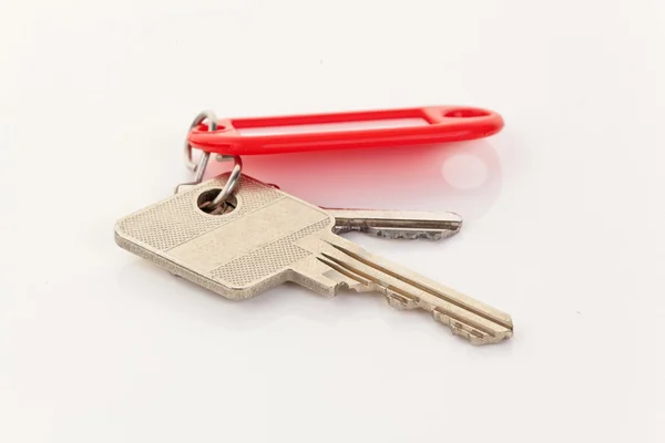Key lying on a white background — Stock Photo, Image