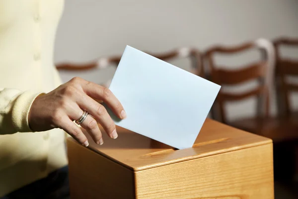 Woman in voting booth Stock Photo