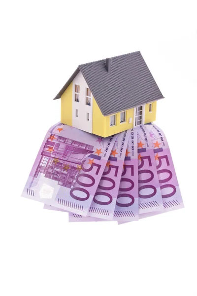 stock image Many euro bills and a house