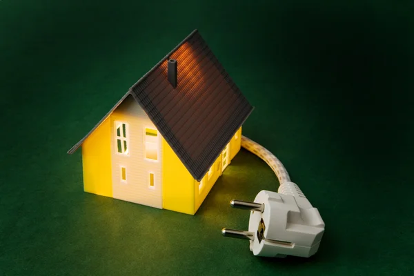 A house with power plug — Stock Photo, Image