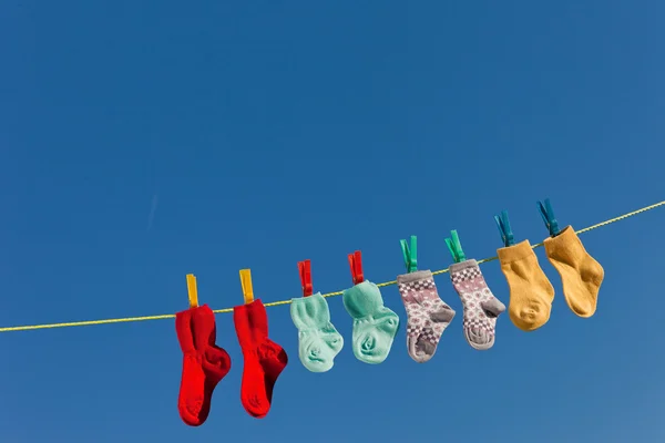 Baby socks on clothesline Royalty Free Stock Photos