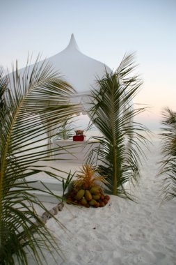 Beach pavilion decorated with palm fronds clipart