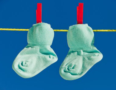Baby socks on clothesline to dry clipart