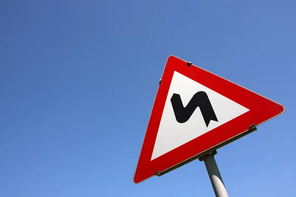 Road sign - Dangerous turn — Stock Photo, Image