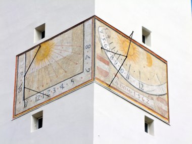 Sundial on a building facade clipart