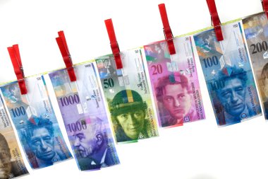 Money laundering with swiss francs on clothesline clipart