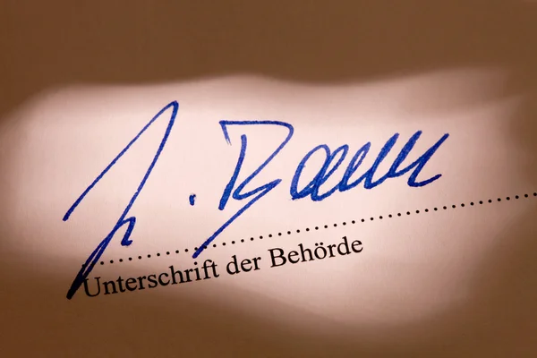 stock image ¶ behãƒâ earths signature to a document bã ¼