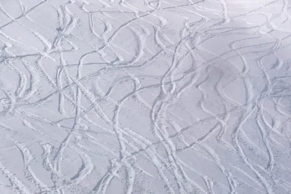 Traces from skiers on a slope with snow — Stock Photo, Image