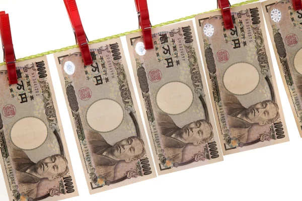 Lavagem de dinheiro e iene japonês no varal — Fotografia de Stock