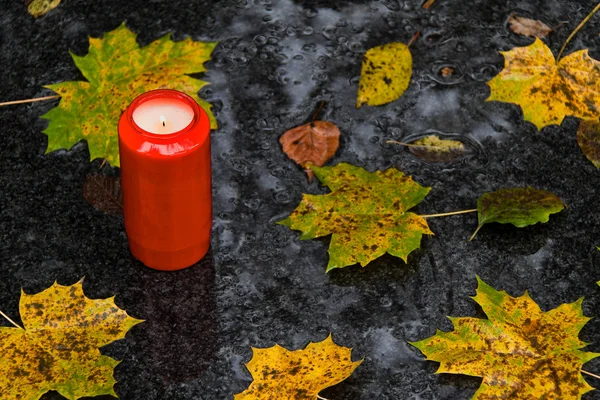 Light grave on all saints day in the fall with lea — Stock Photo, Image