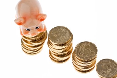 Piles of coins from piggy bank with euro coins clipart