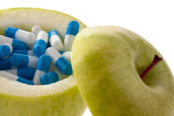 Apple tablets with capsules. symbol for vitamin ta — Stock Photo, Image