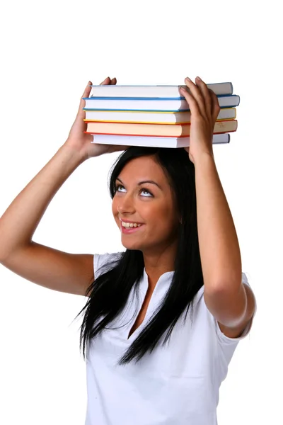 Jeune femme avec une pile de livres sur la tête — Photo