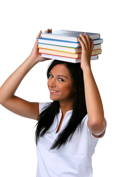 Mulher jovem com uma pilha de livros na cabeça — Fotografia de Stock