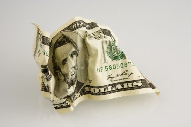 Crumpled money. Isolated over white. clipart