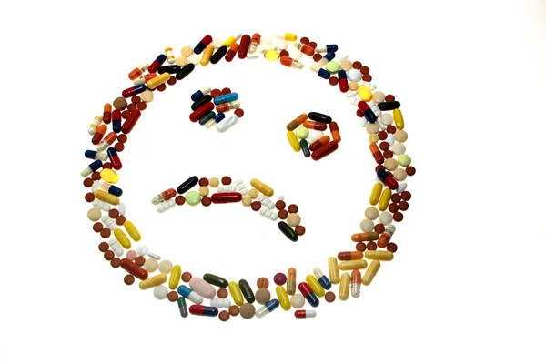 Smiling face made from different pills — Stock Photo, Image