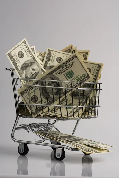 Cesta de compras con billetes de dólar —  Fotos de Stock