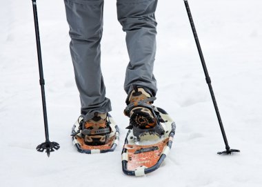 Senior when snowshoeing in winter clipart