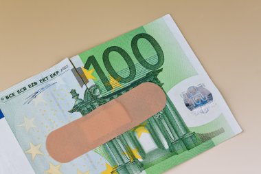 Euro bank notes with adhesive plaster clipart