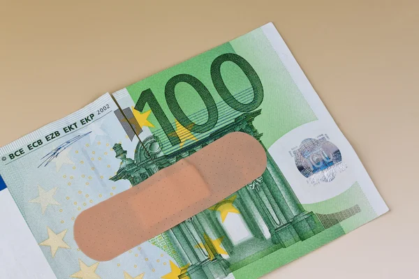 Euro bank notes with adhesive plaster — Stock Photo, Image