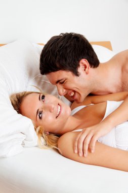 Couple has fun in bed clipart