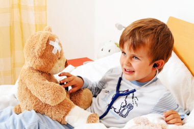 Sick child teddy examined clipart