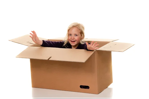 Child in moving box. — Stock Photo, Image