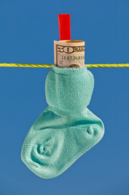 Baby socks on clothesline with dollar clipart