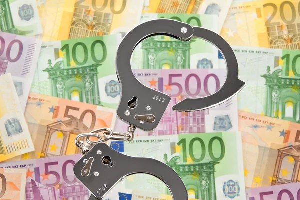 Банкноты евро с наручниками — стоковое фото