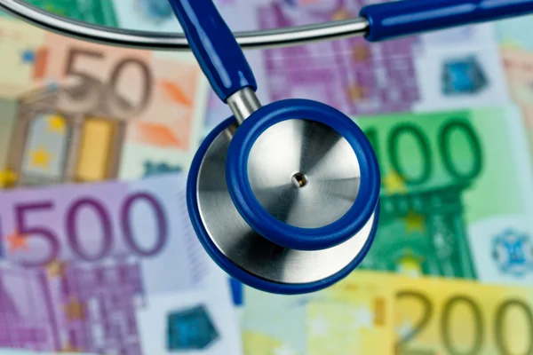 stock image Many euro bank notes with stethoscope.