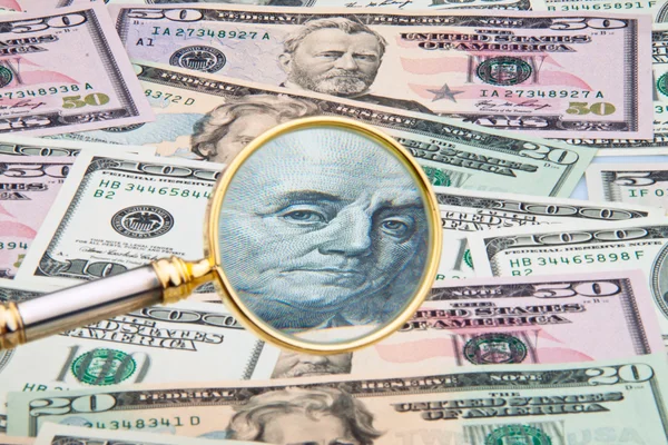 Dollar currency notes photographed with a magnifying glass — Stock Photo, Image